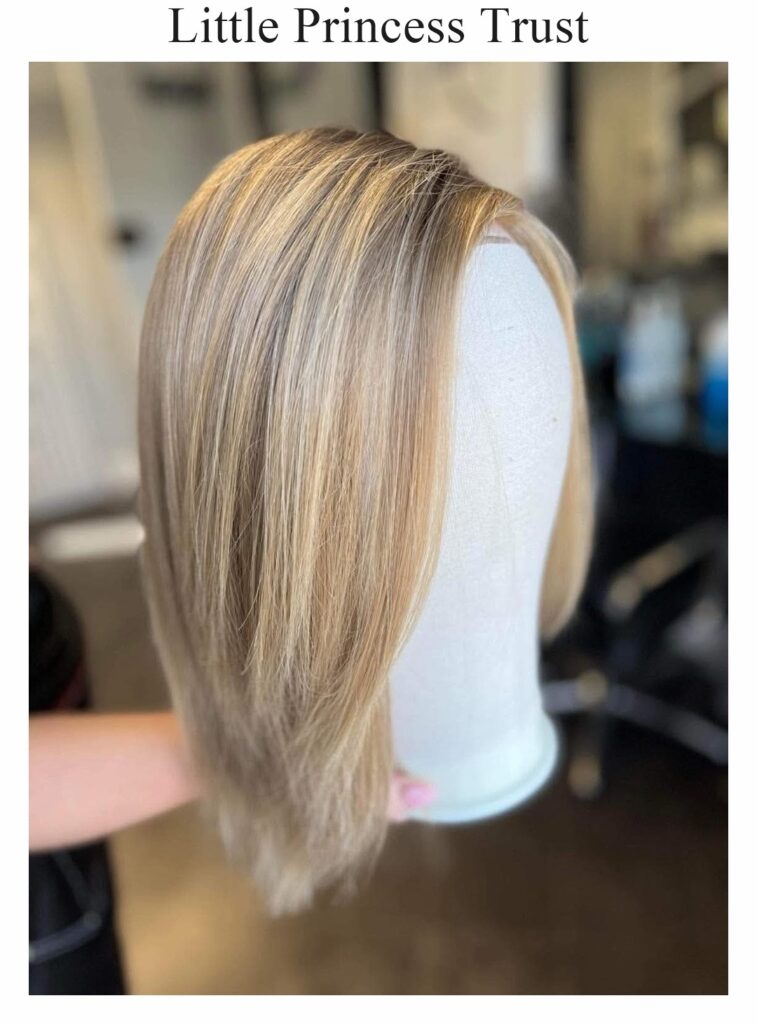 Little Princess Trust wig: a long, straight blonde wig with highlights, on a stand