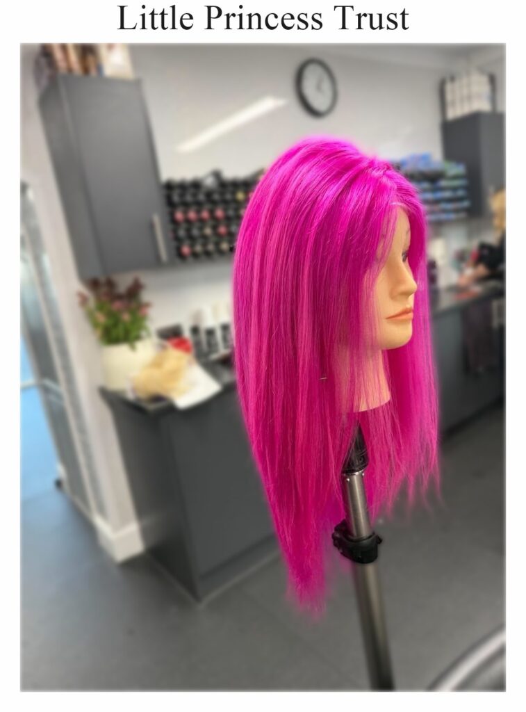 Little Princess Trust wig: a long, straight bright pink wig on a stand