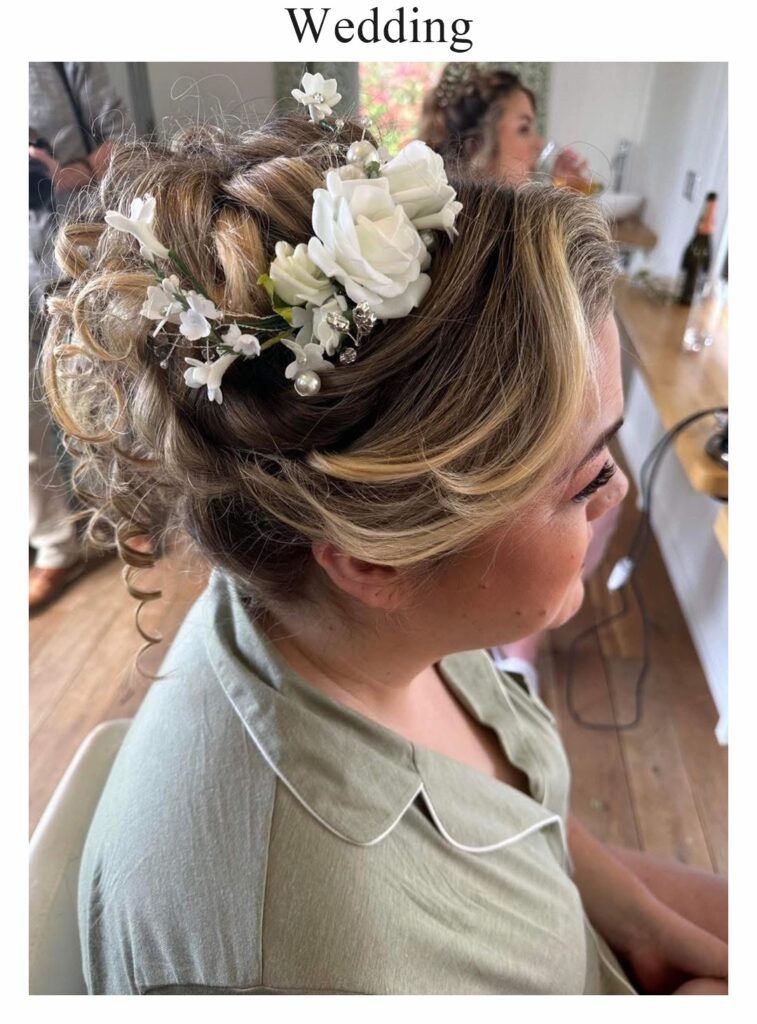 Wedding hair: a textured blonde updo with white roses
